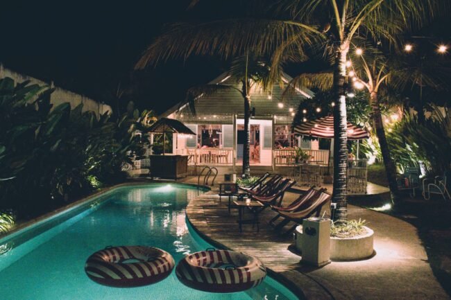 Resort-style backyard with pool and lighting.