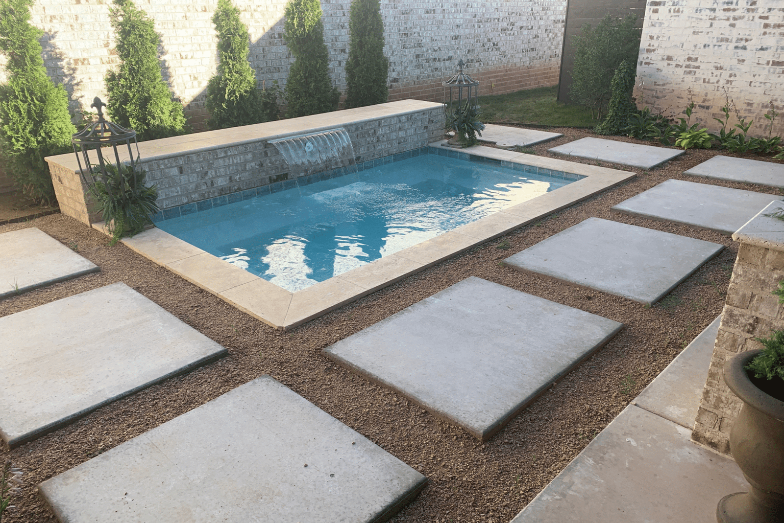 Modern cocktail pool with clean tile deck and spa-style seating in Amarillo, Texas