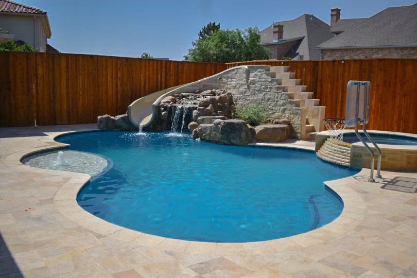 Custom inground swimming pool with rock waterfall feature in Amarillo, Texas